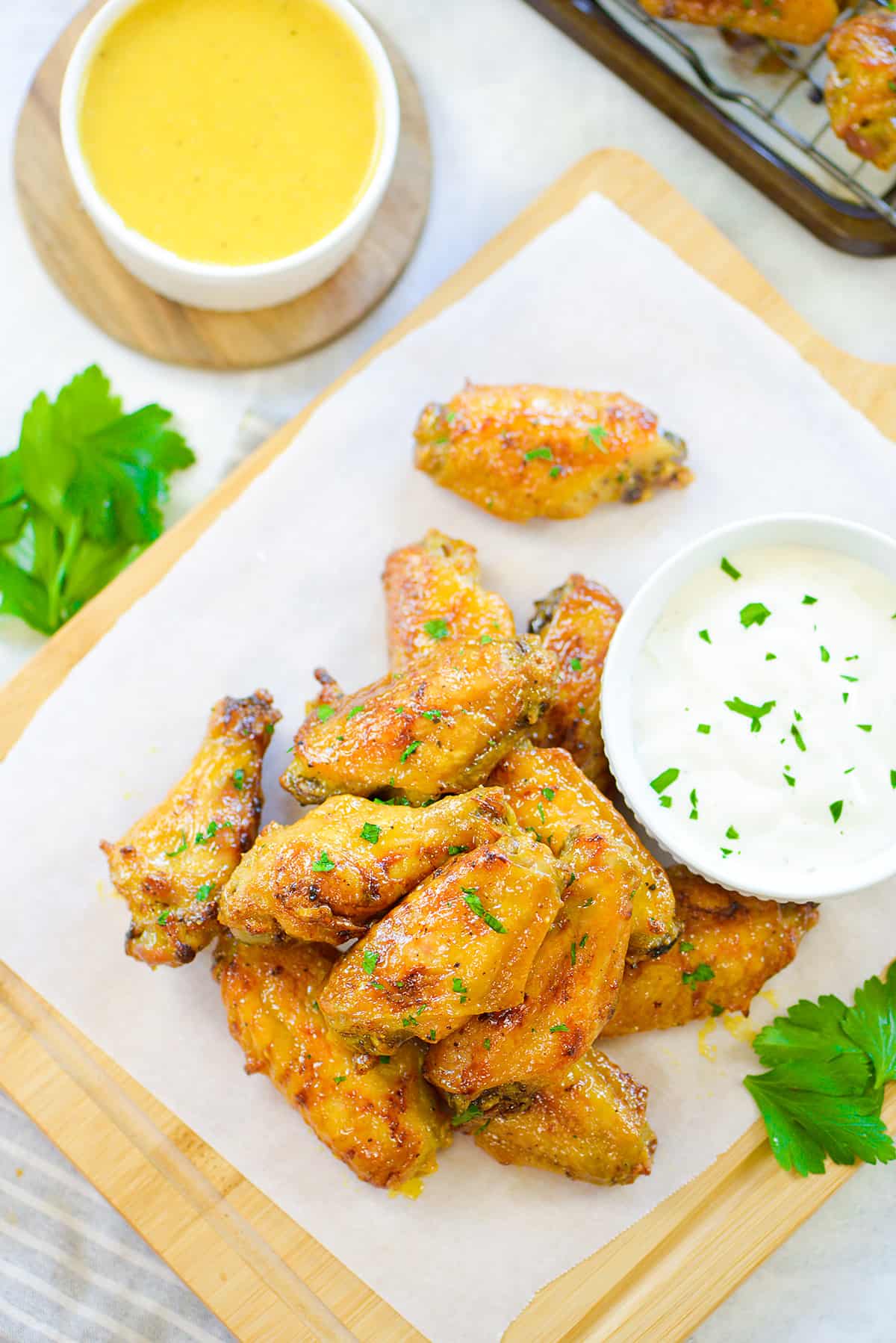 Overhead view of honey mustard wings on parchment.