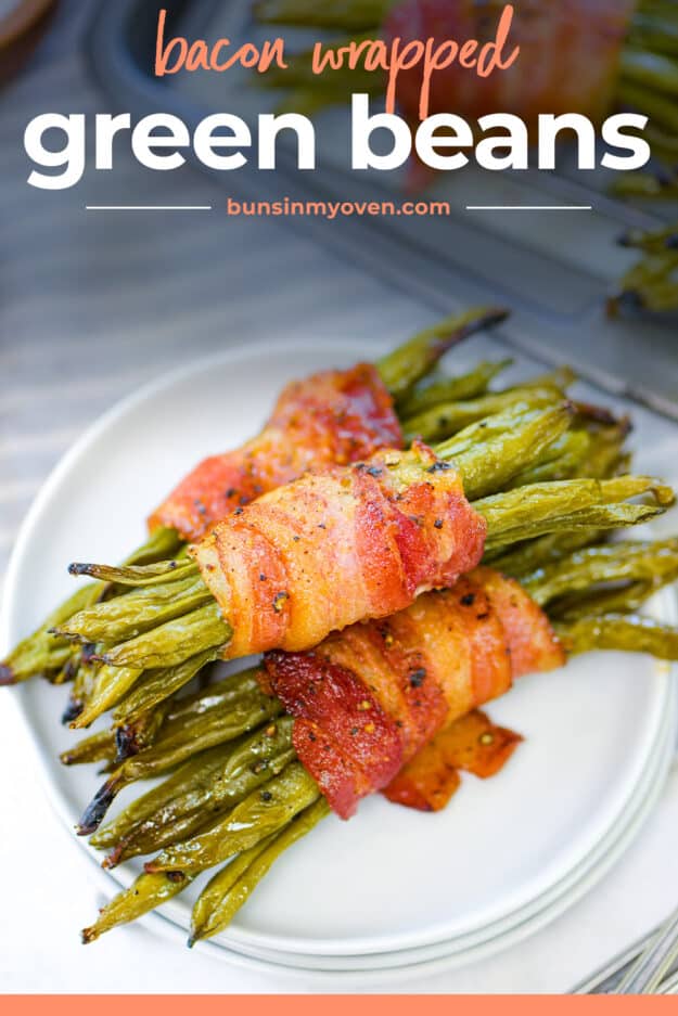 Green beans wrapped in bacon on white plate.