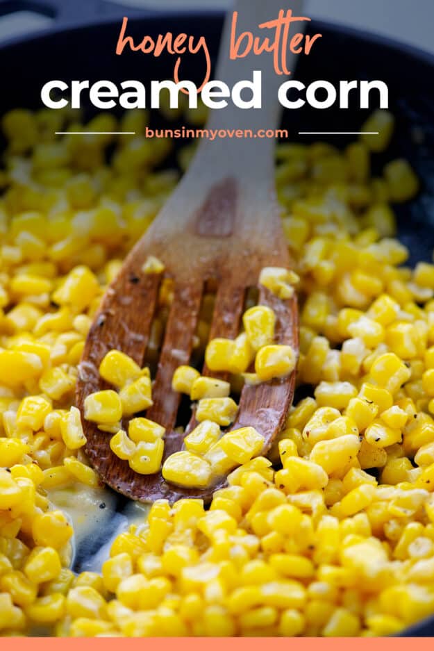 Wooden spoon in skillet full of corn.