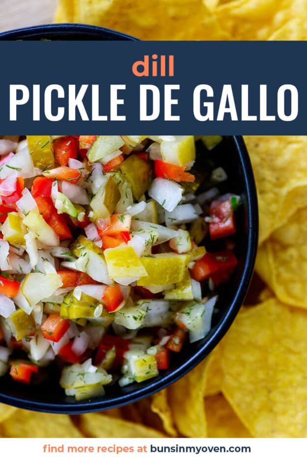 overhead view of pickle de gallo dip in black bowl surrounded by chips.