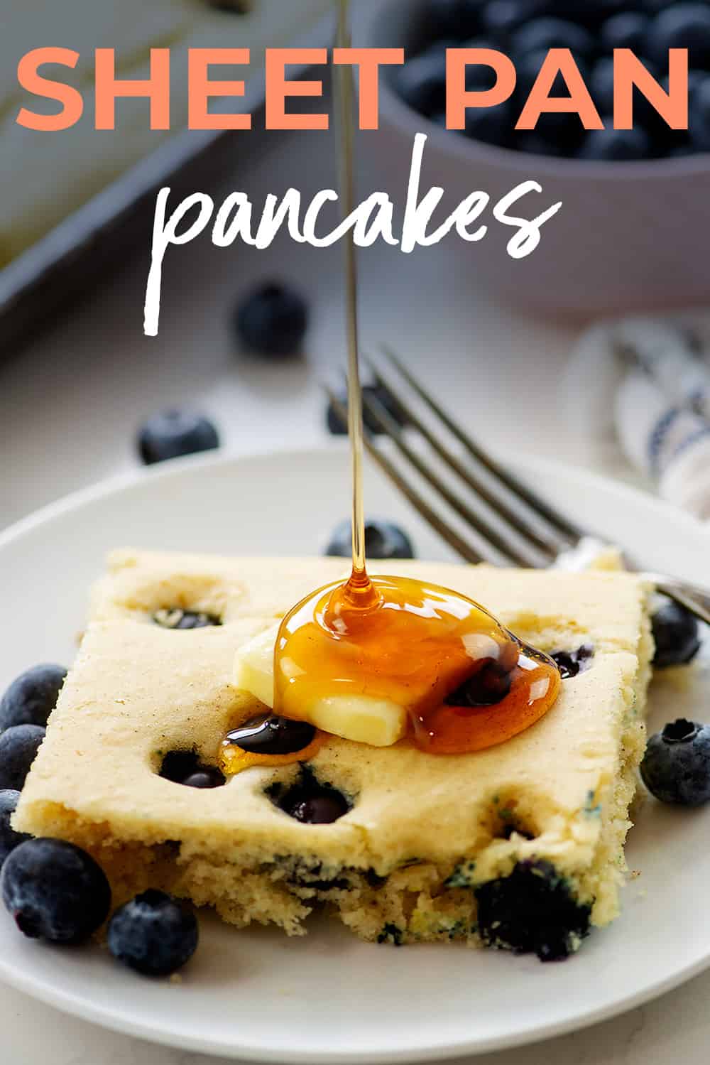 Syrup being drizzled over a sheet pan pancake.