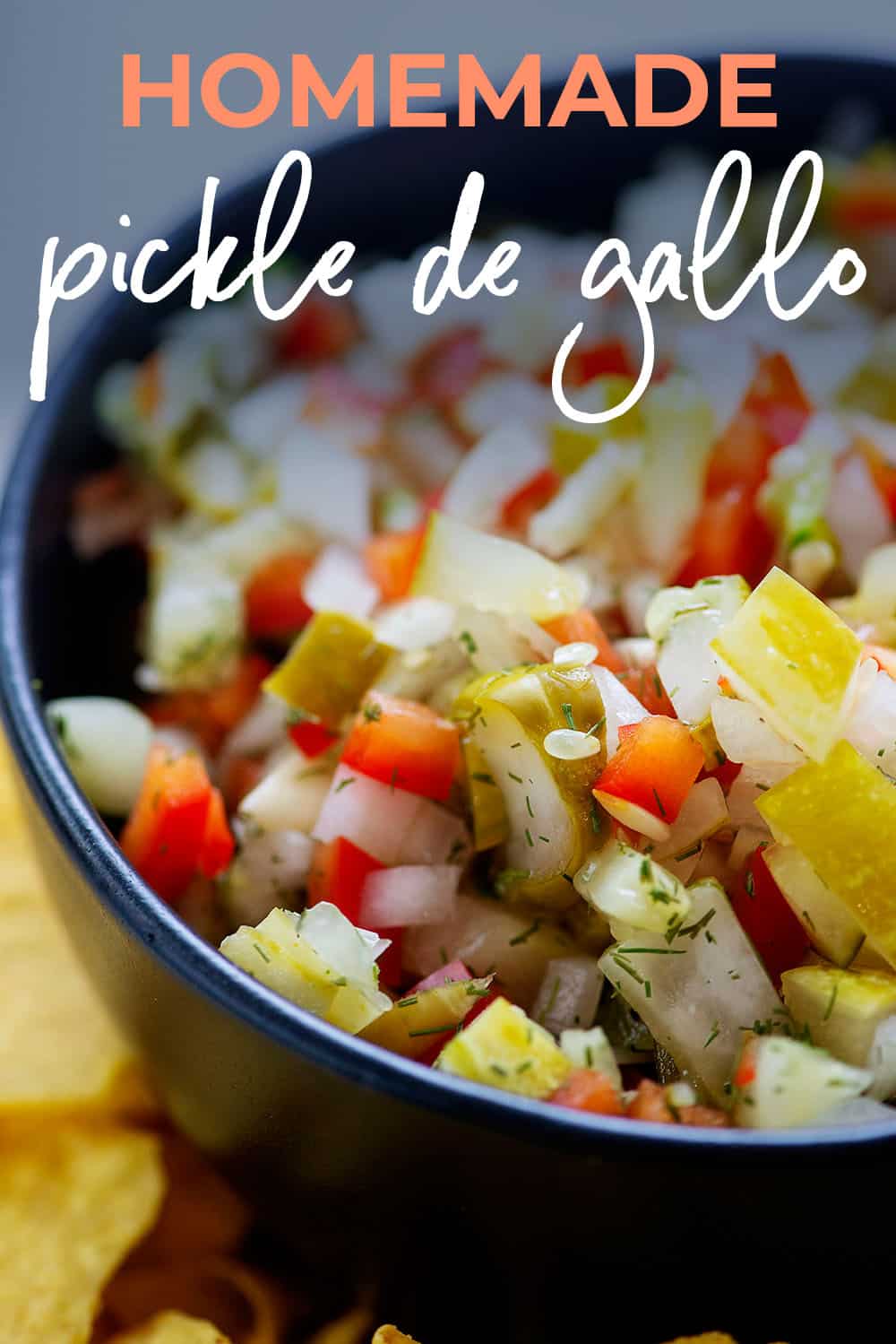 homemade pickle de gallo dip in black bowl. with text for pinterest.