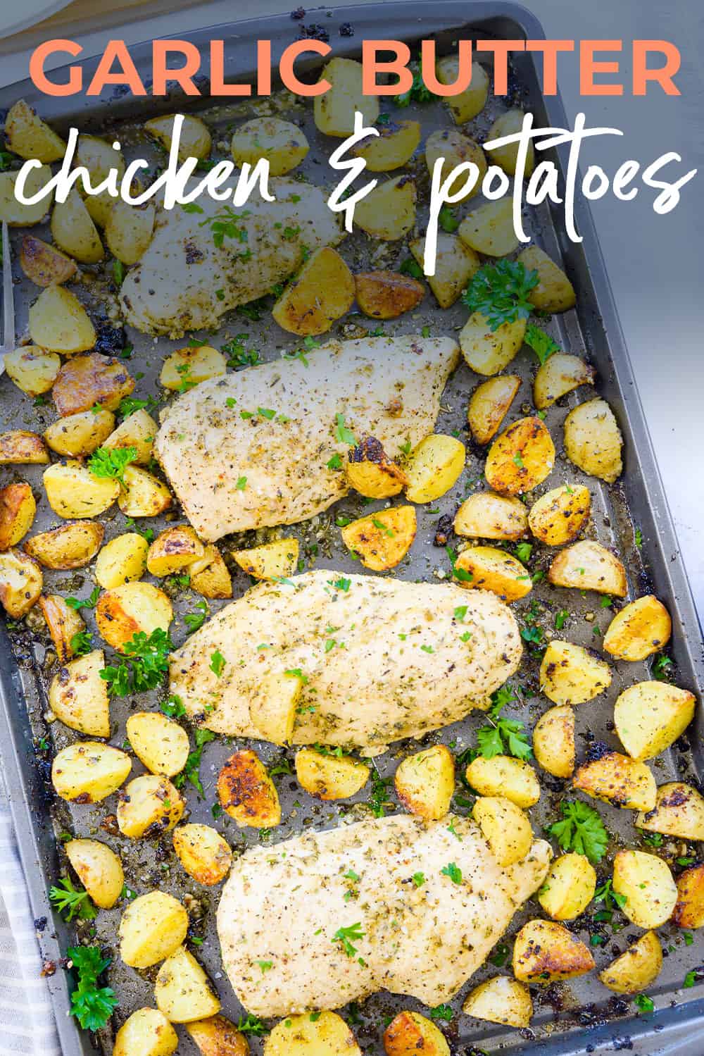 overhead view of chicken and potatoes on sheet pan.