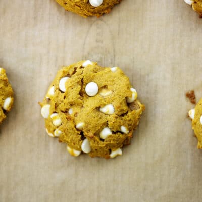 baked white chocolate chip pumpkin cookies on cookie sheet.
