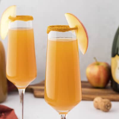 apple cider mimosas in glasses.