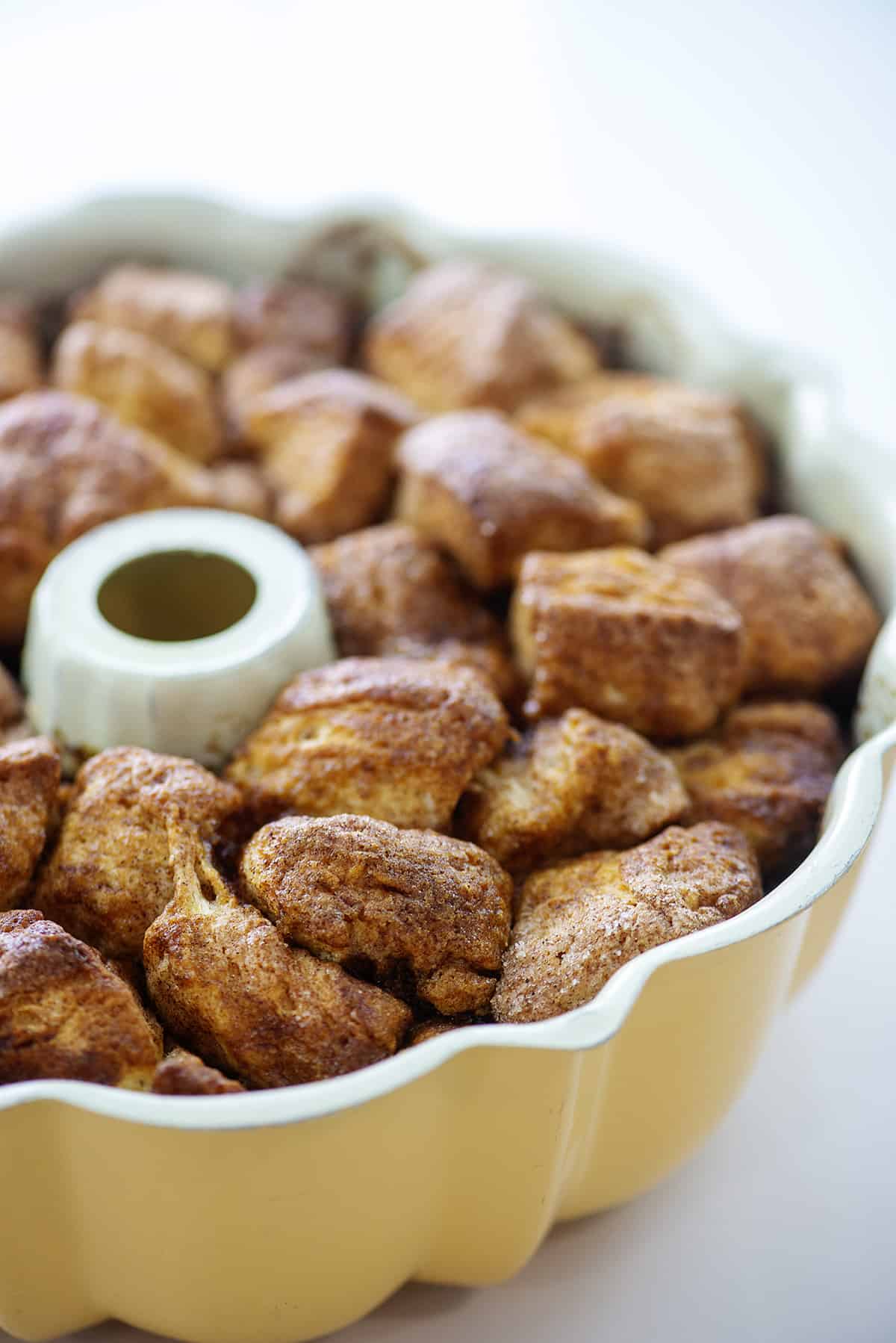 Baked pumpkin monkey bread cooling in bundt pan.