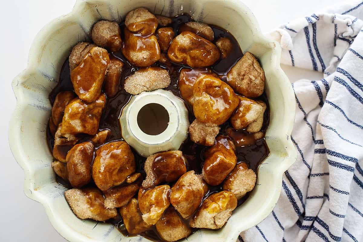 Caramel sauce poured over biscuits in bundt pan.