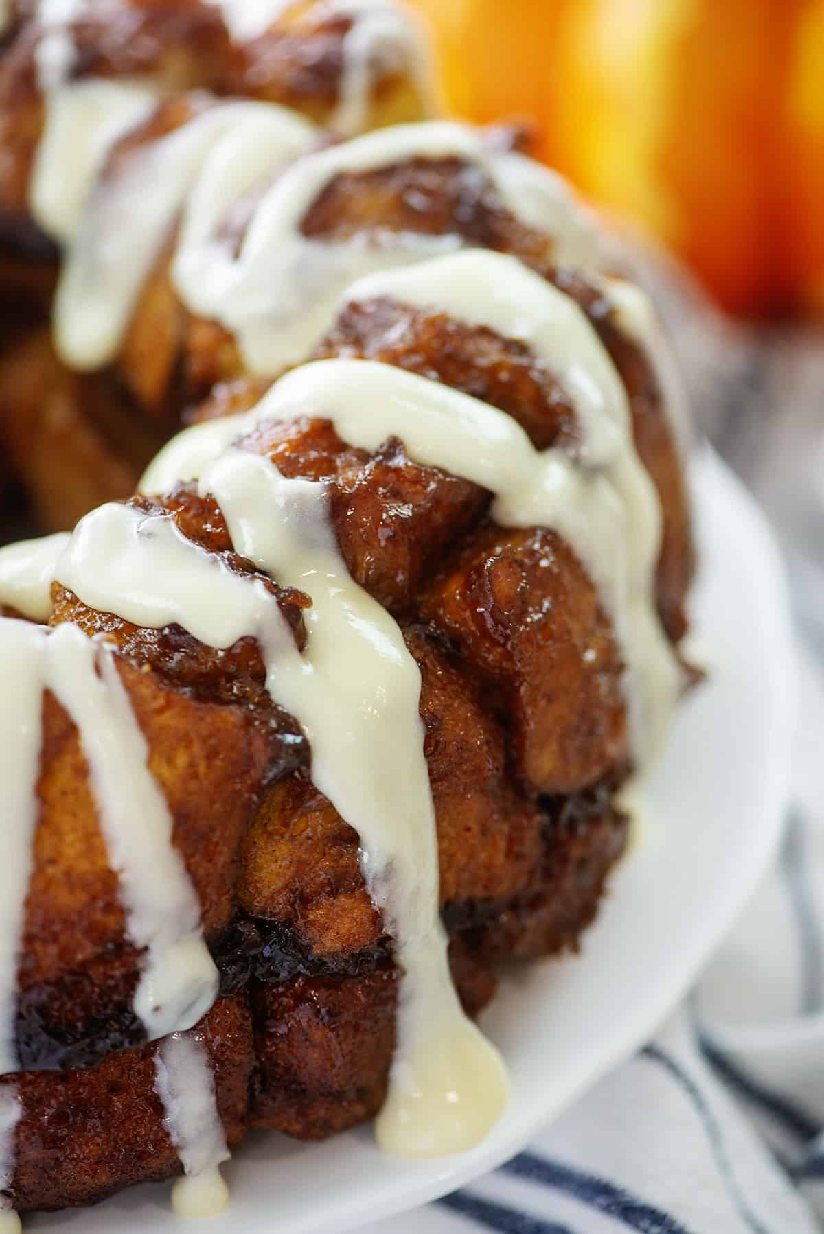 Cream cheese glaze drizzled over pumpkin monkey bread.