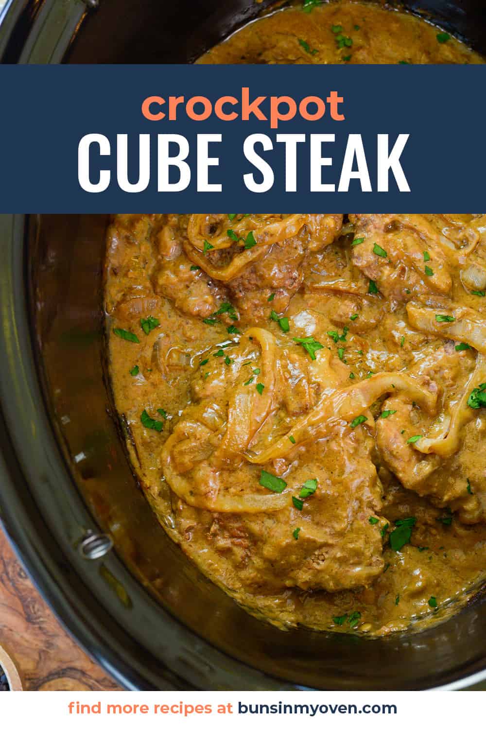 Overhead view of crock pot full of cube steak and gravy.