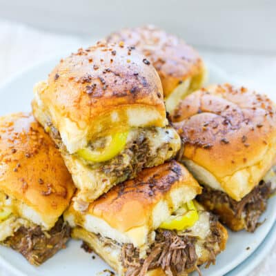 Stack of pot roast sliders on plate.