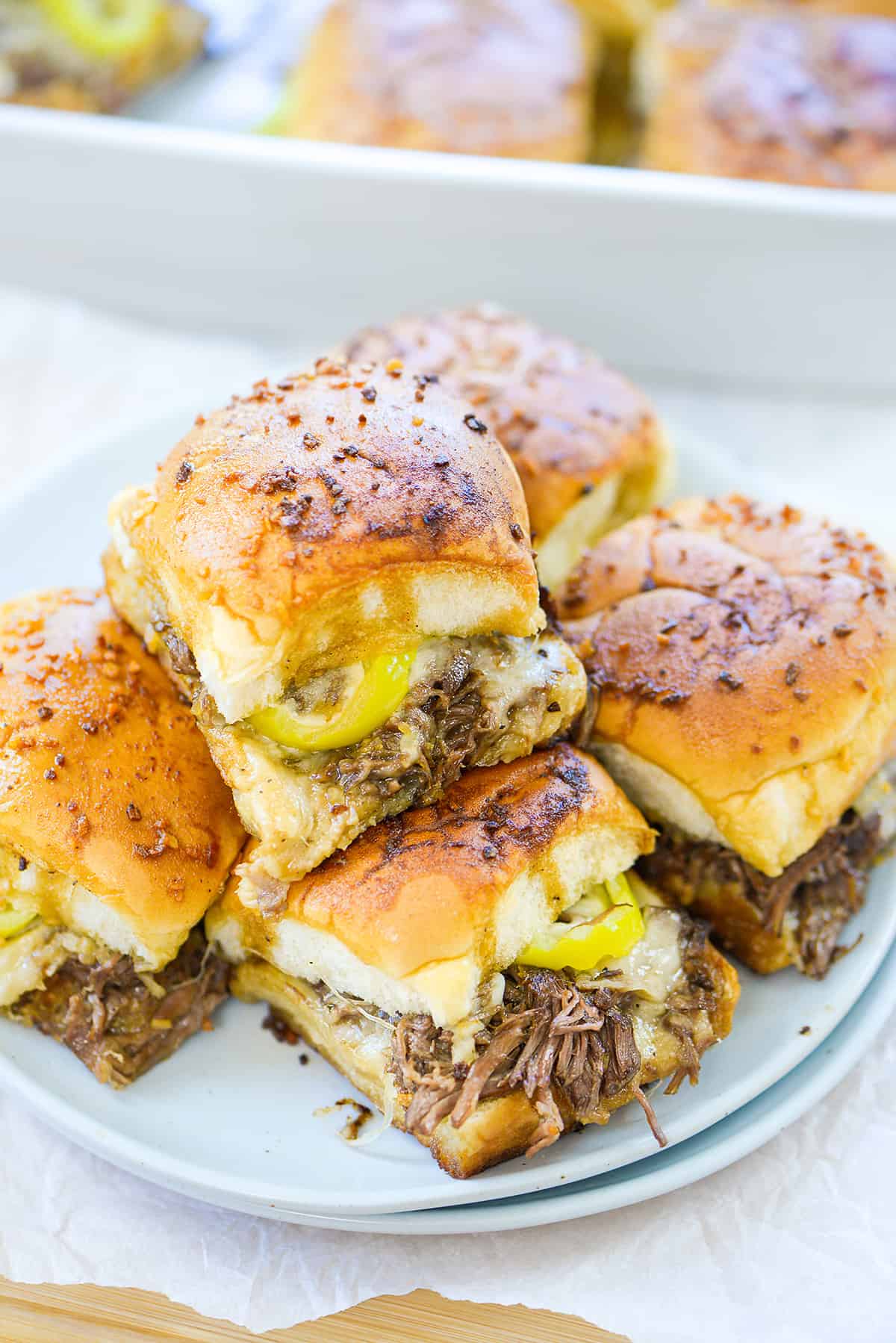 Stack of pot roast sliders on plate.