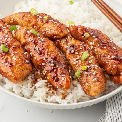 Chicken tenders in bowl of rice.