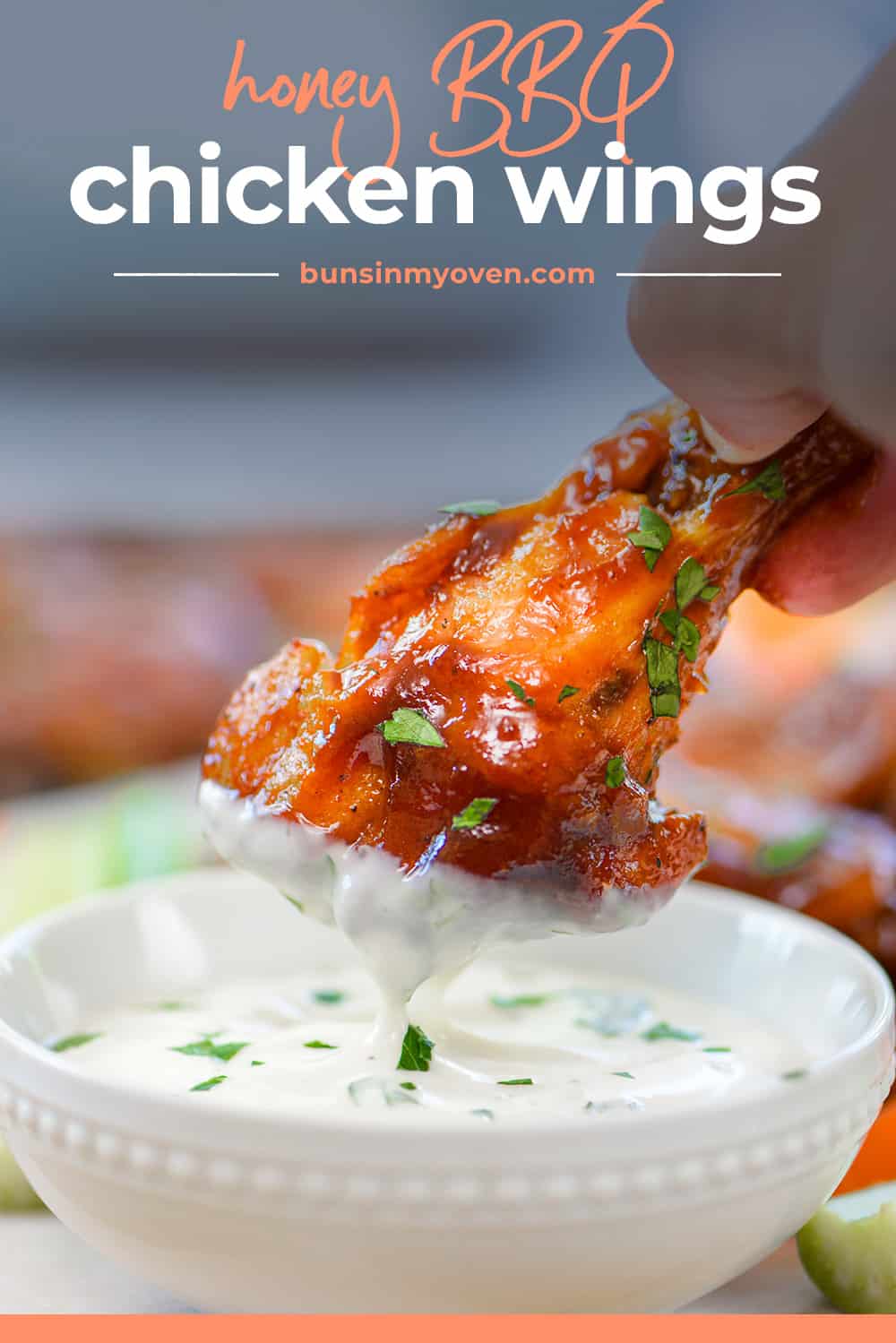 BBQ chicken wing being dipped in ranch.