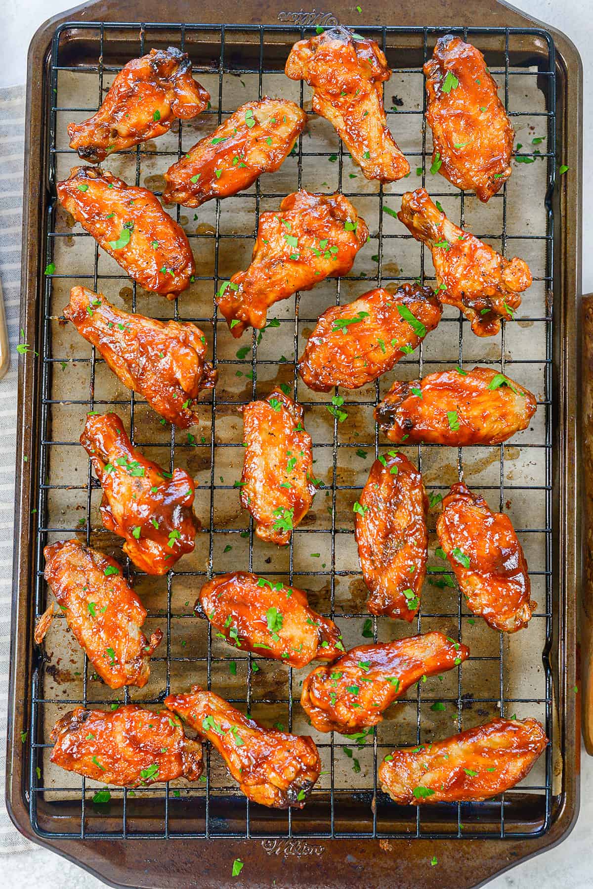 Baked BBQ wings on sheet pan.