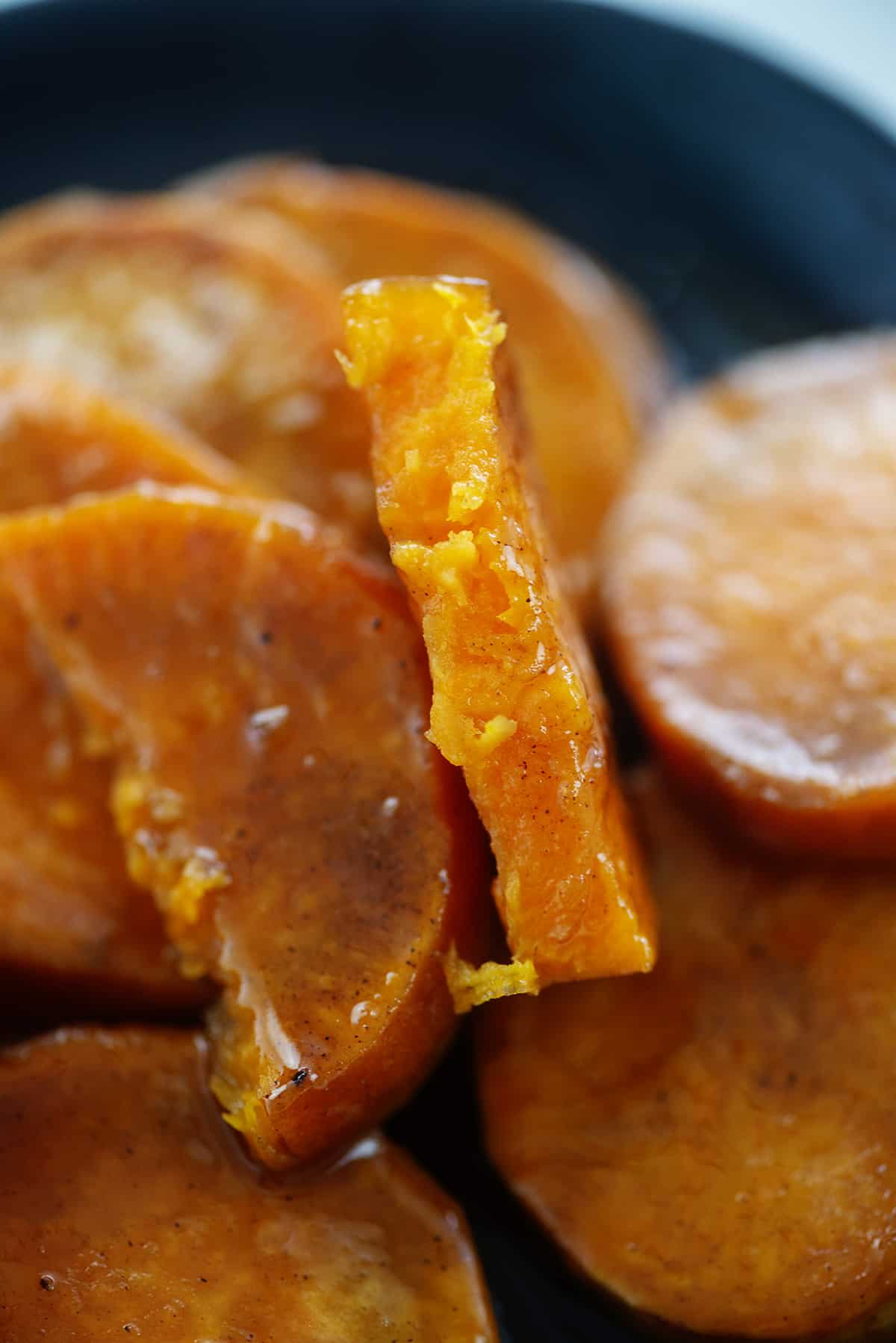 Sliced candied sweet potato on plate.