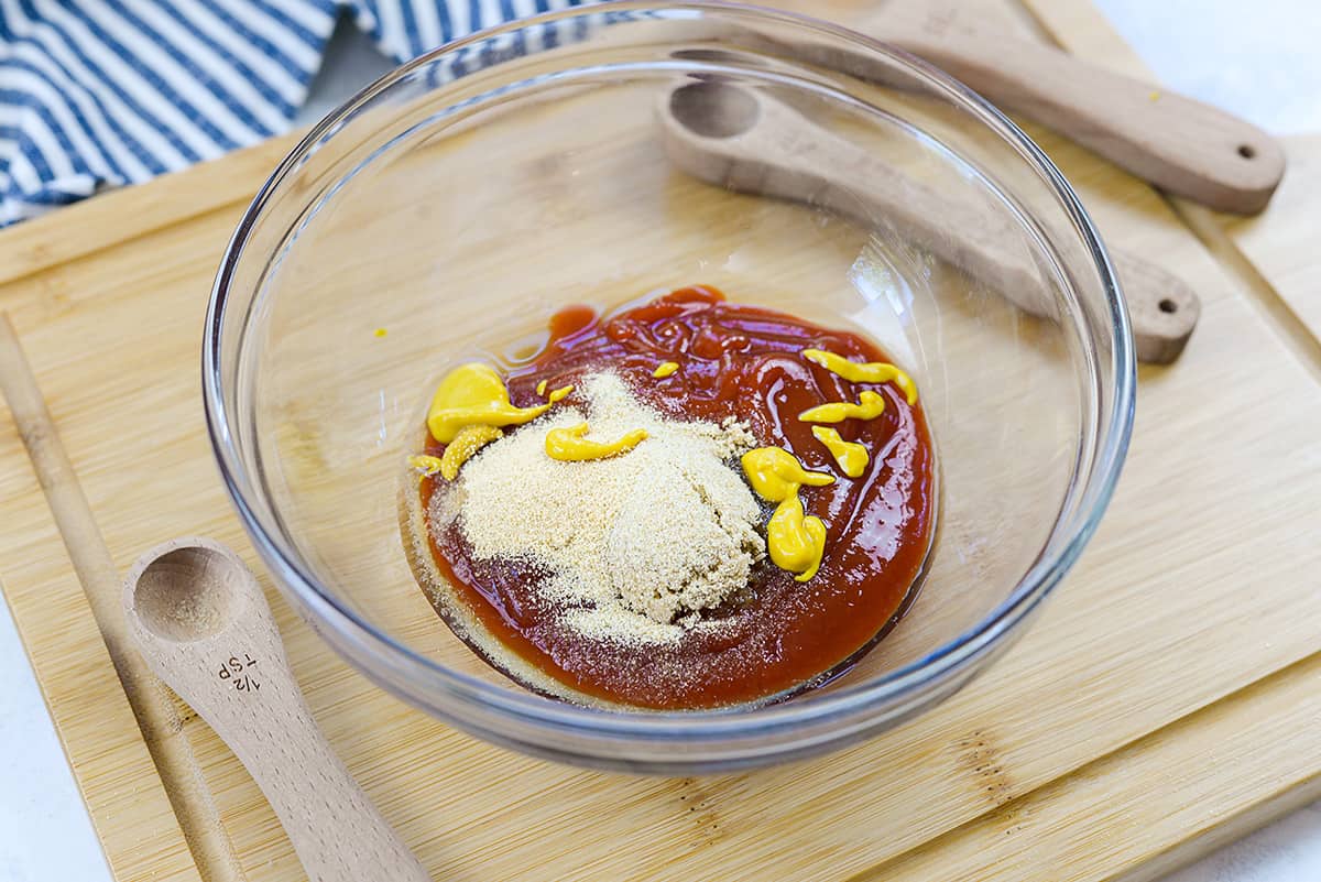 Ingredients for meatloaf sauce in glass bowl.