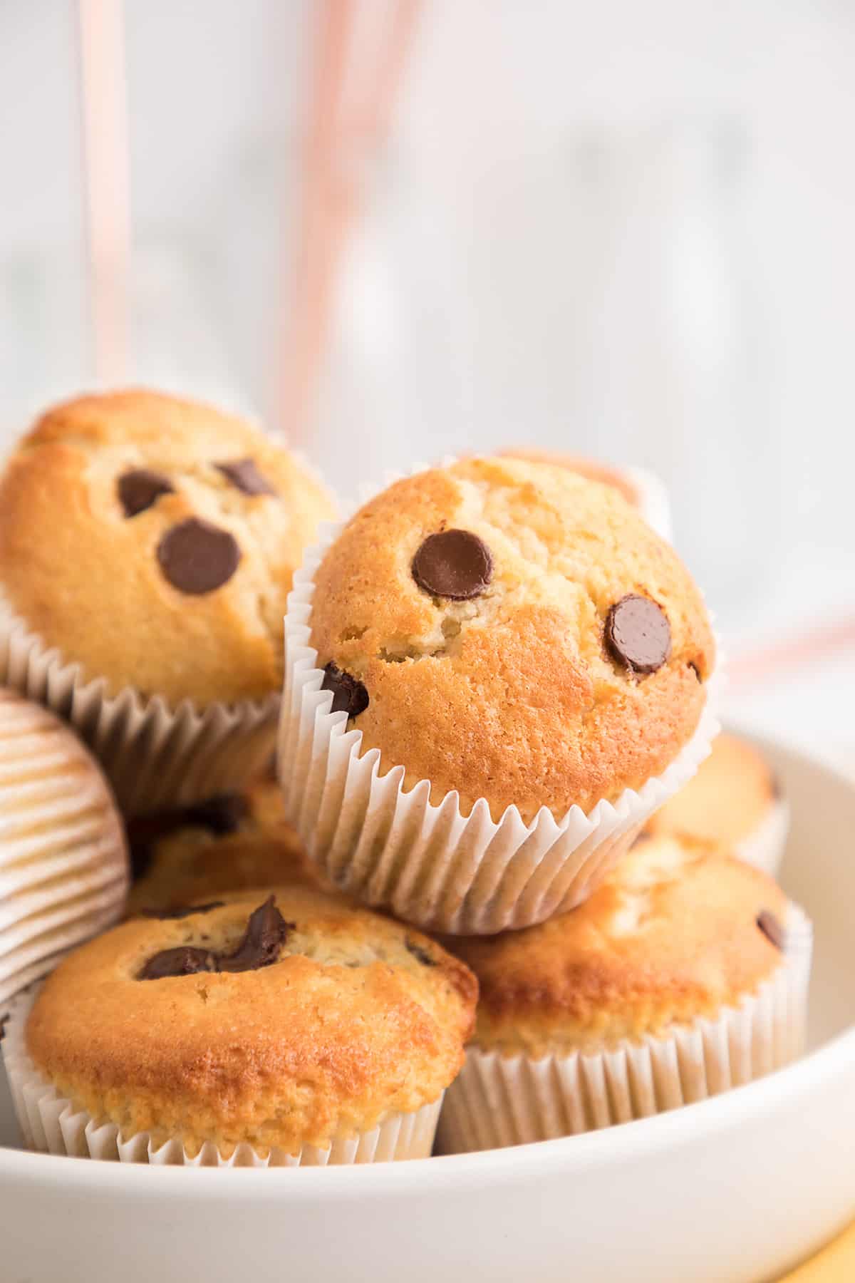 Muffins stacked on white plate.