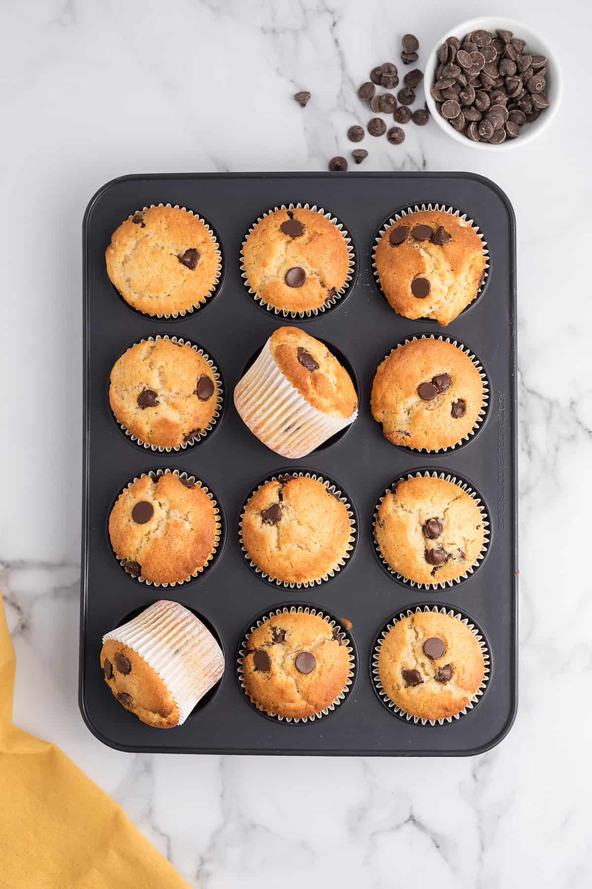 Muffin tin full of cake mix muffins.