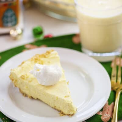 Slice of eggnog pie on white plate.