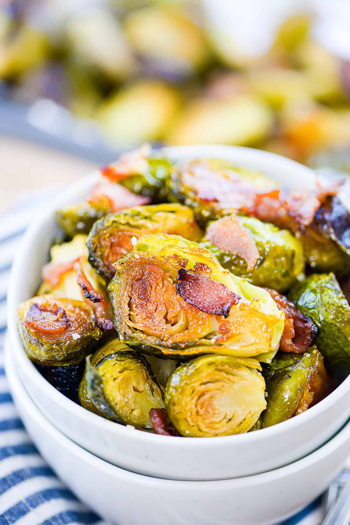 White bowl full of roasted brussels sprouts.
