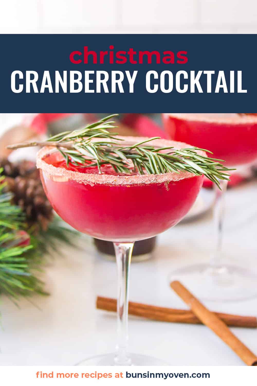 Christmas cocktail in glass with sprig of rosemary.