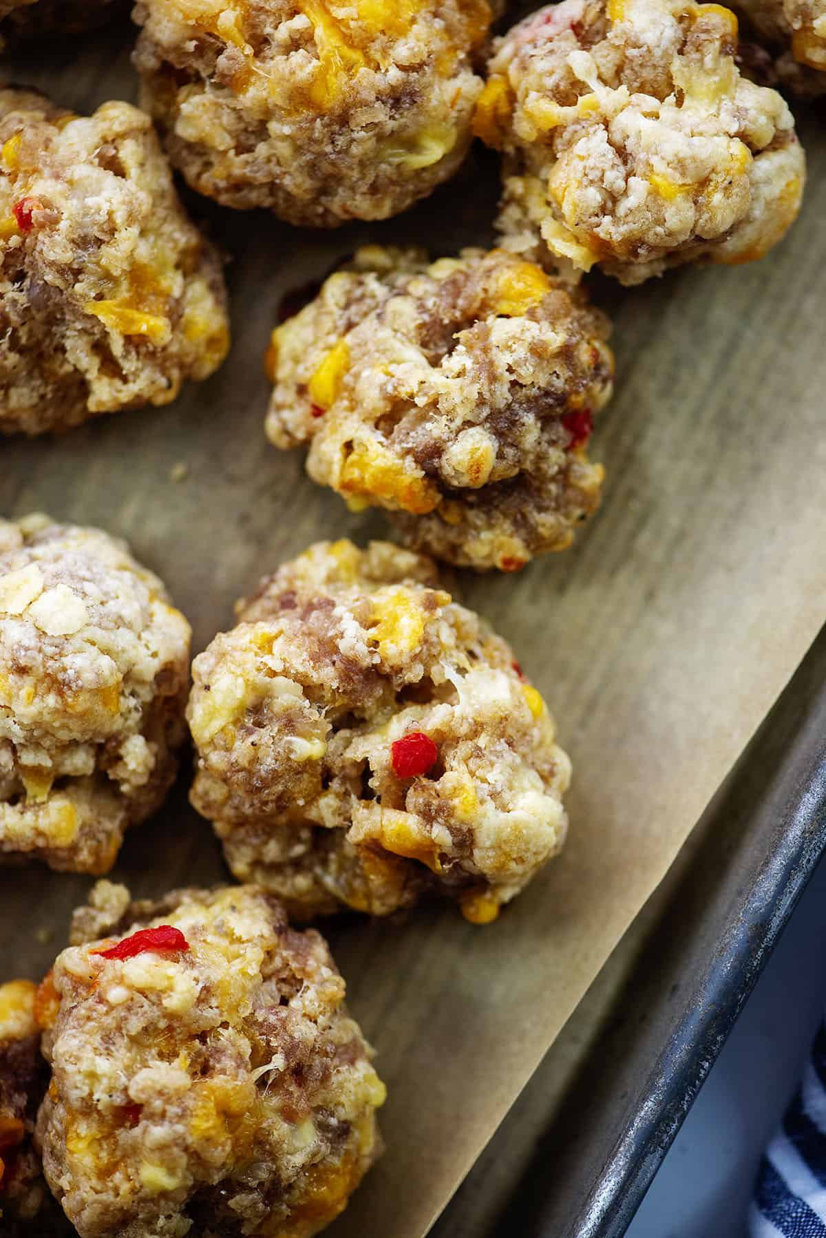 Overhead view of pimento cheese sausage balls on baking sheet.