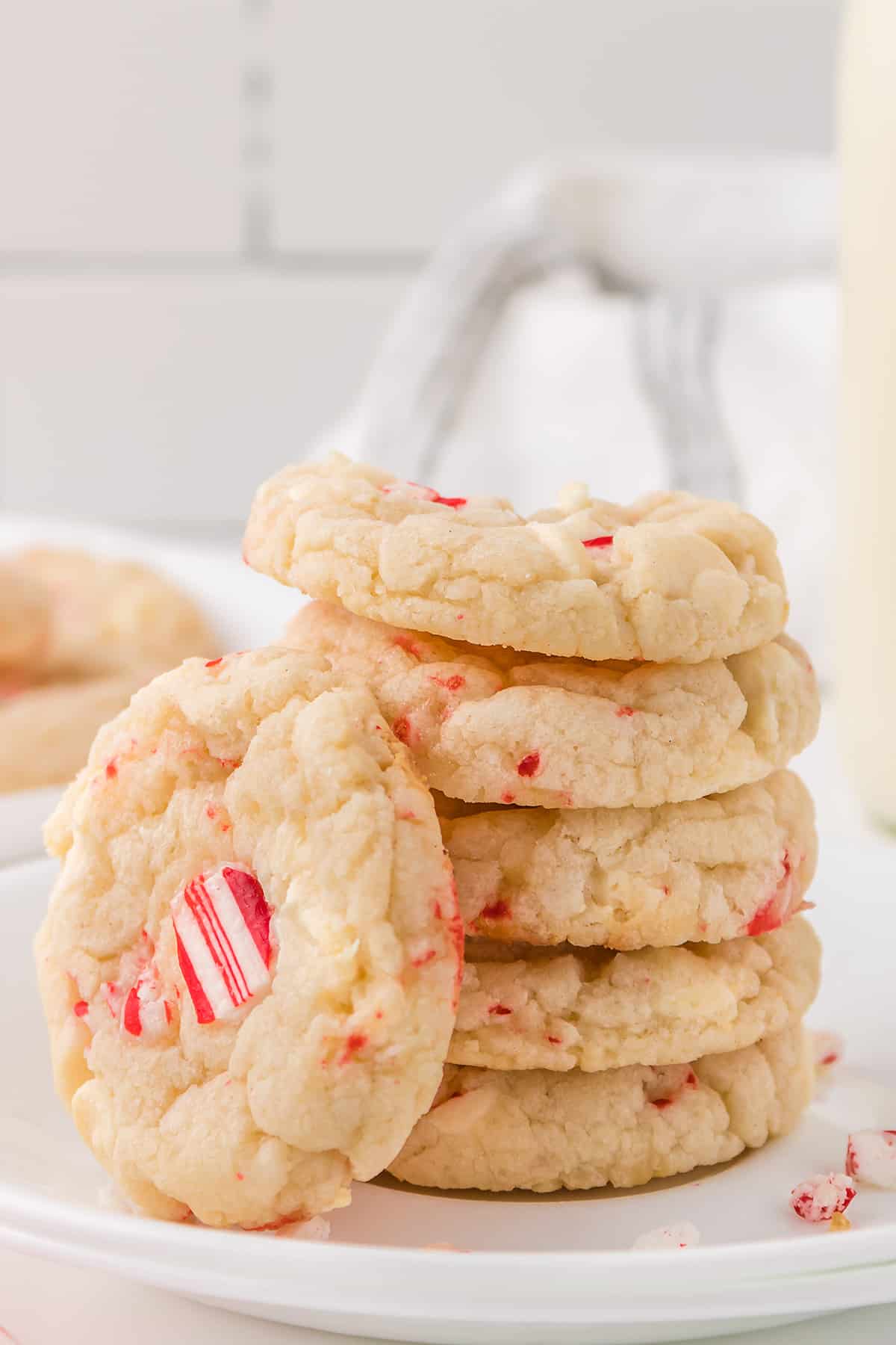 Stack of white chocolate peppermint cookies on white plate.