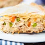 Slice of turkey pot pie recipe on white plate.
