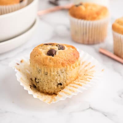 Bakery style chocolate chip muffin on liner.