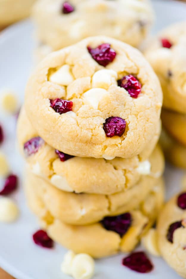 Stack of white chocolate cranberry cookies on baking sheet.