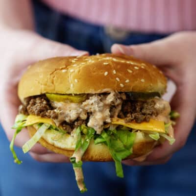 Woman holding a Big Mac sloppy joe.