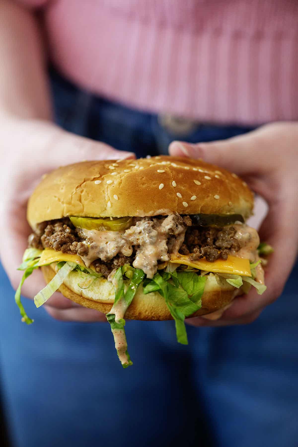 Woman holding a Big Mac sloppy joe.