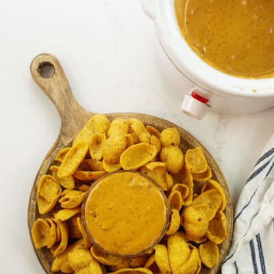 Overhead view of chili cheese dip surrounded by Fritos.