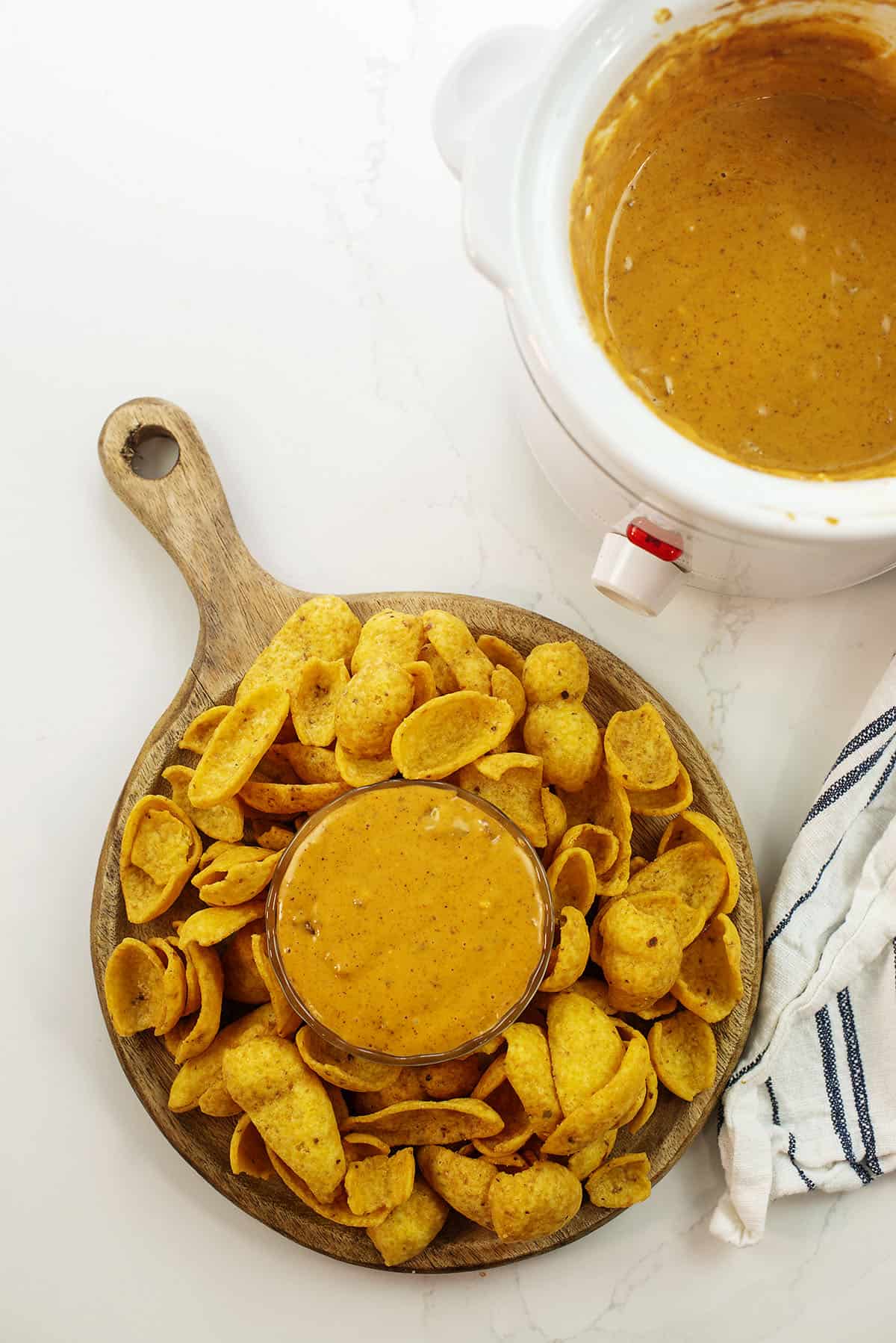 Overhead view of chili cheese dip surrounded by Fritos.