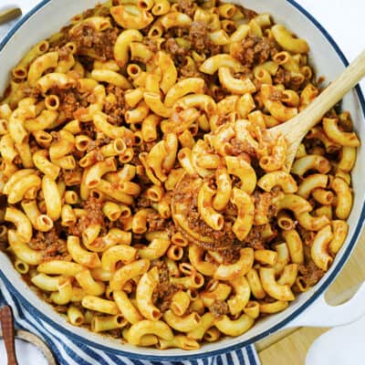 Beefaroni in white skillet.