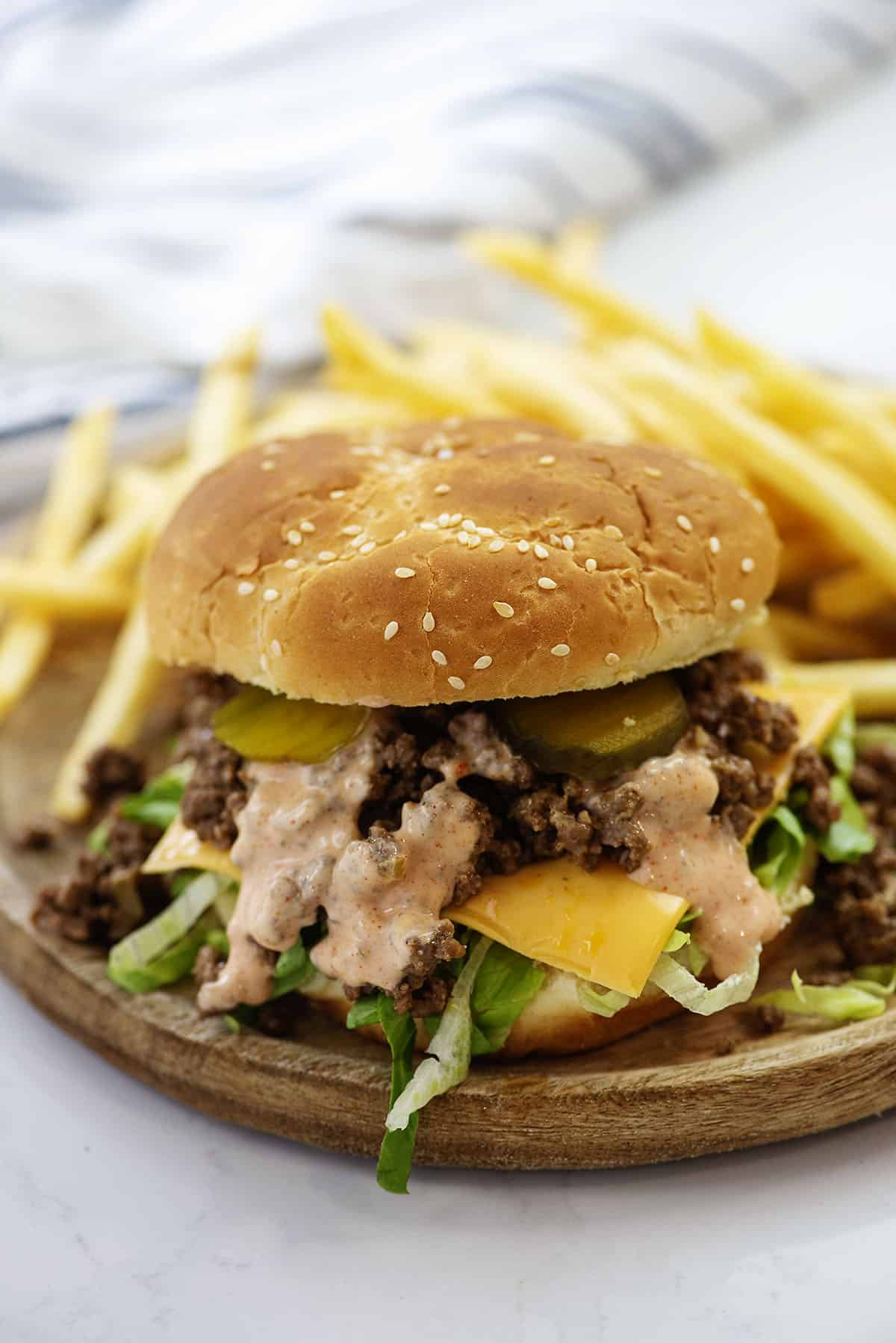 Big mac sloppy joe on board with fries.