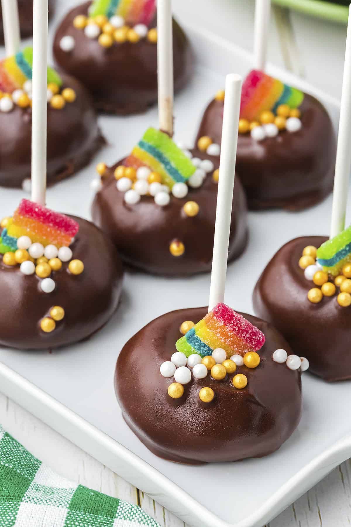 St. Patricks' Day cookie pops on white tray.
