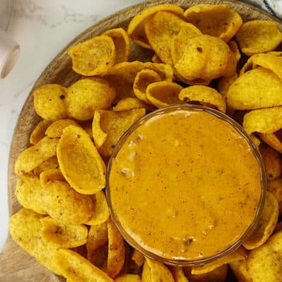 Overhead view of chili cheese dip in glas bowl.