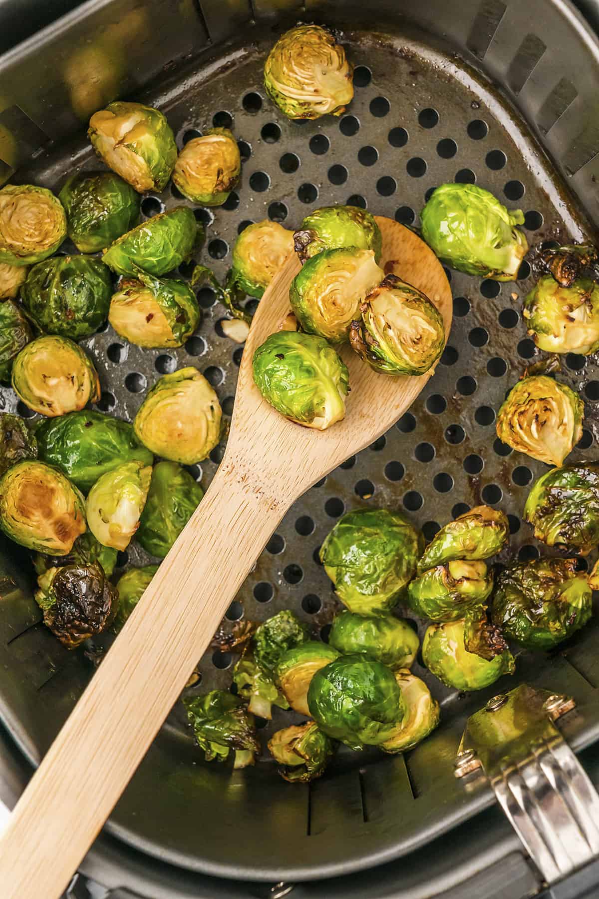 Brussels sprouts in air fryer basket.