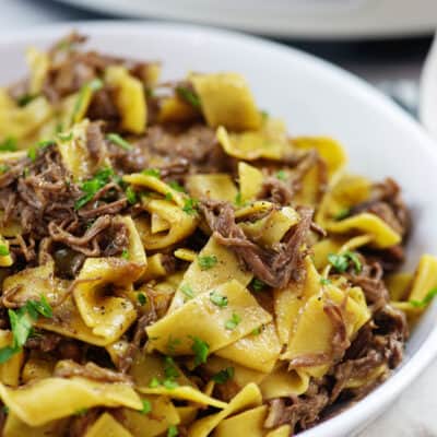 Mississippi beef and noodles in white bowl.