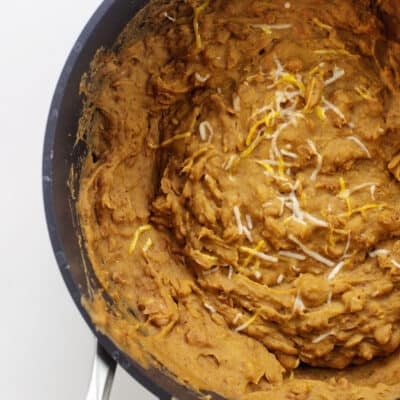 Refried beans in black skillet.