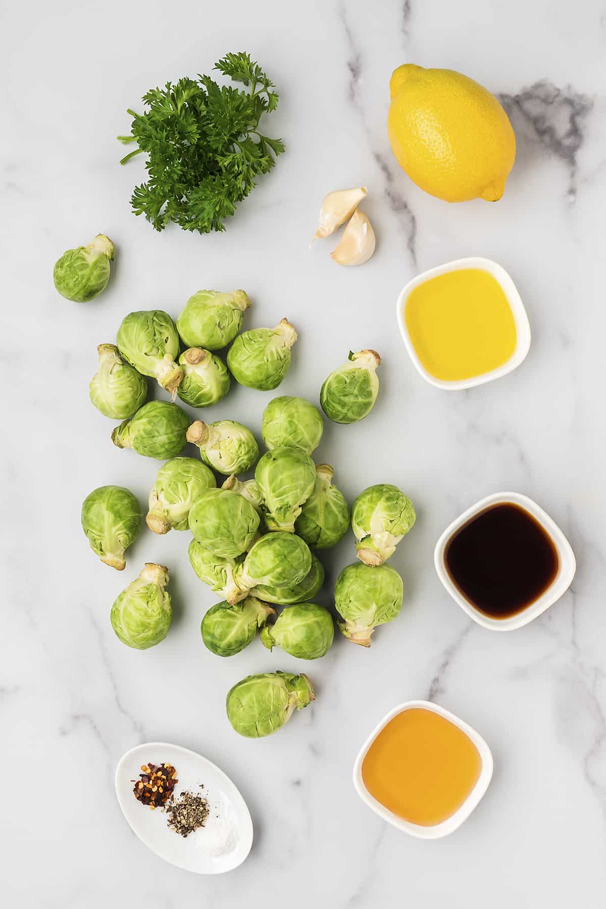 Ingredients for making air fryer brussels sprouts on white counter.