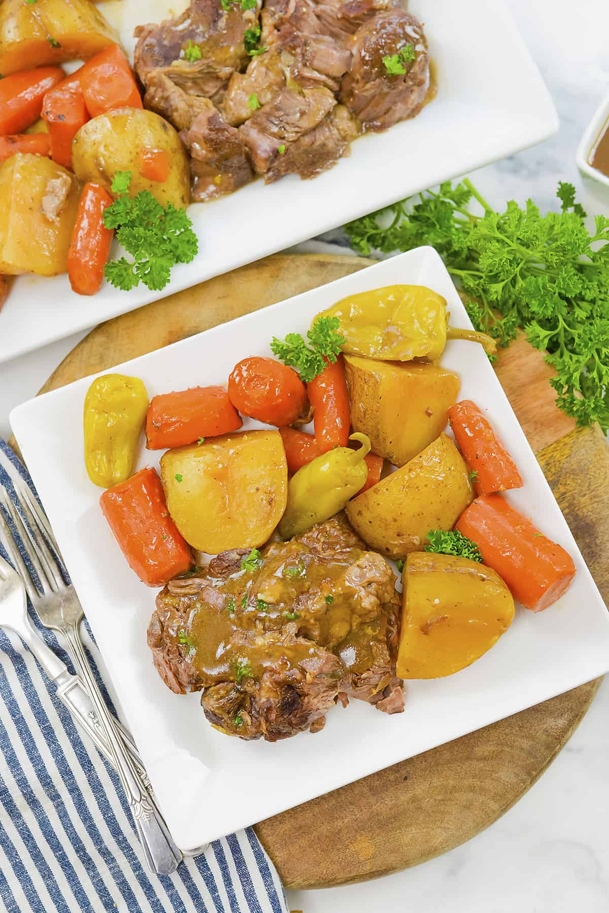 Plate of pot roast, carrots, and potatoes.