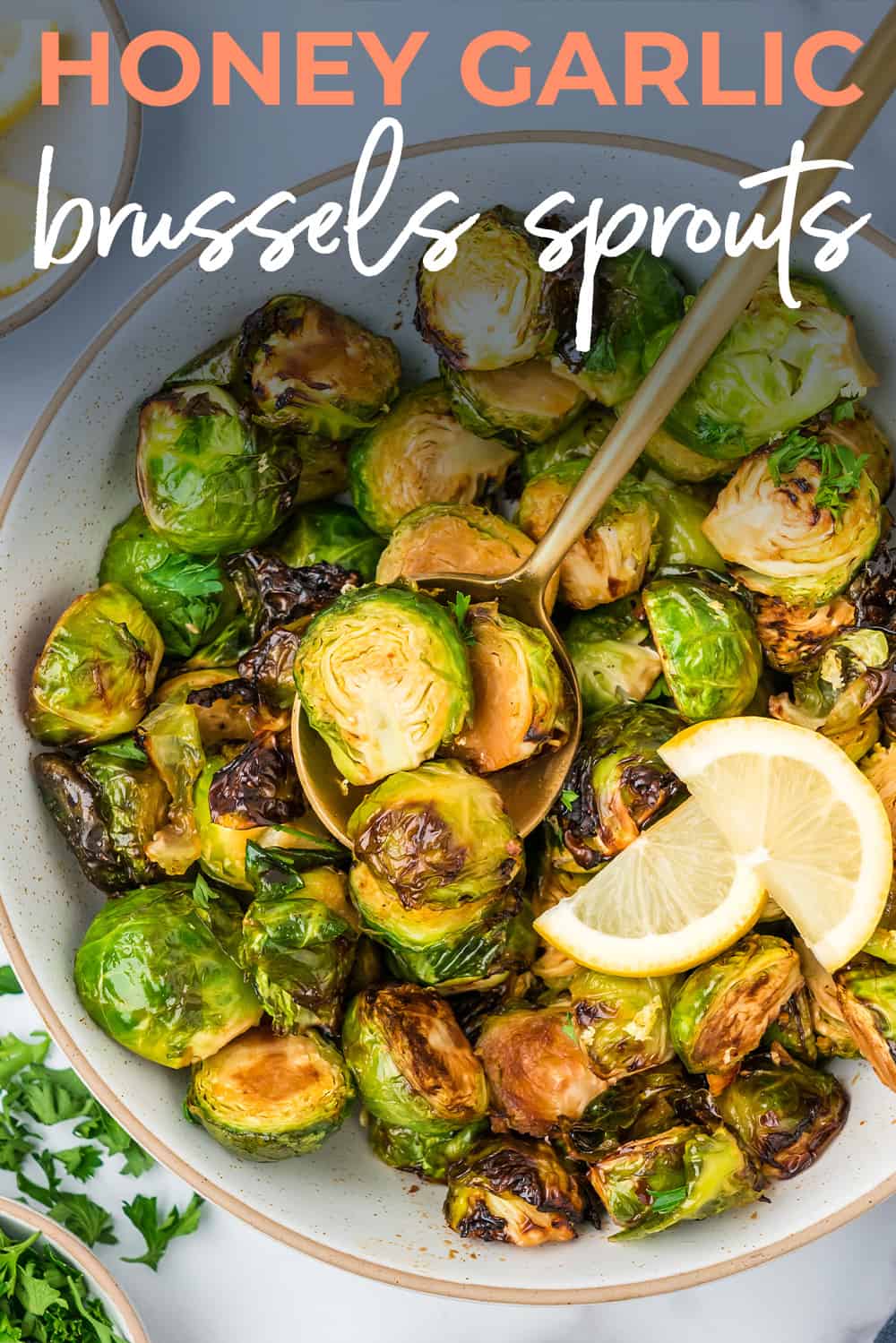 Honey garlic Brussels sprouts on gold spoon in bowl.