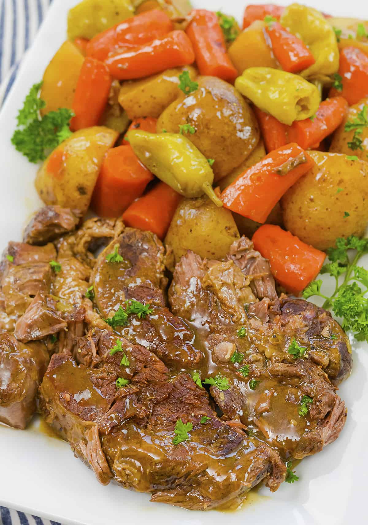 Close up of beef roast with vegetables.