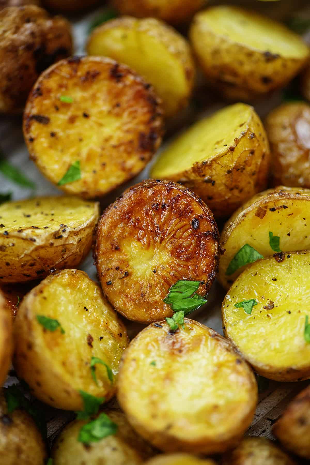 Pile of roasted potatoes on baking sheet.