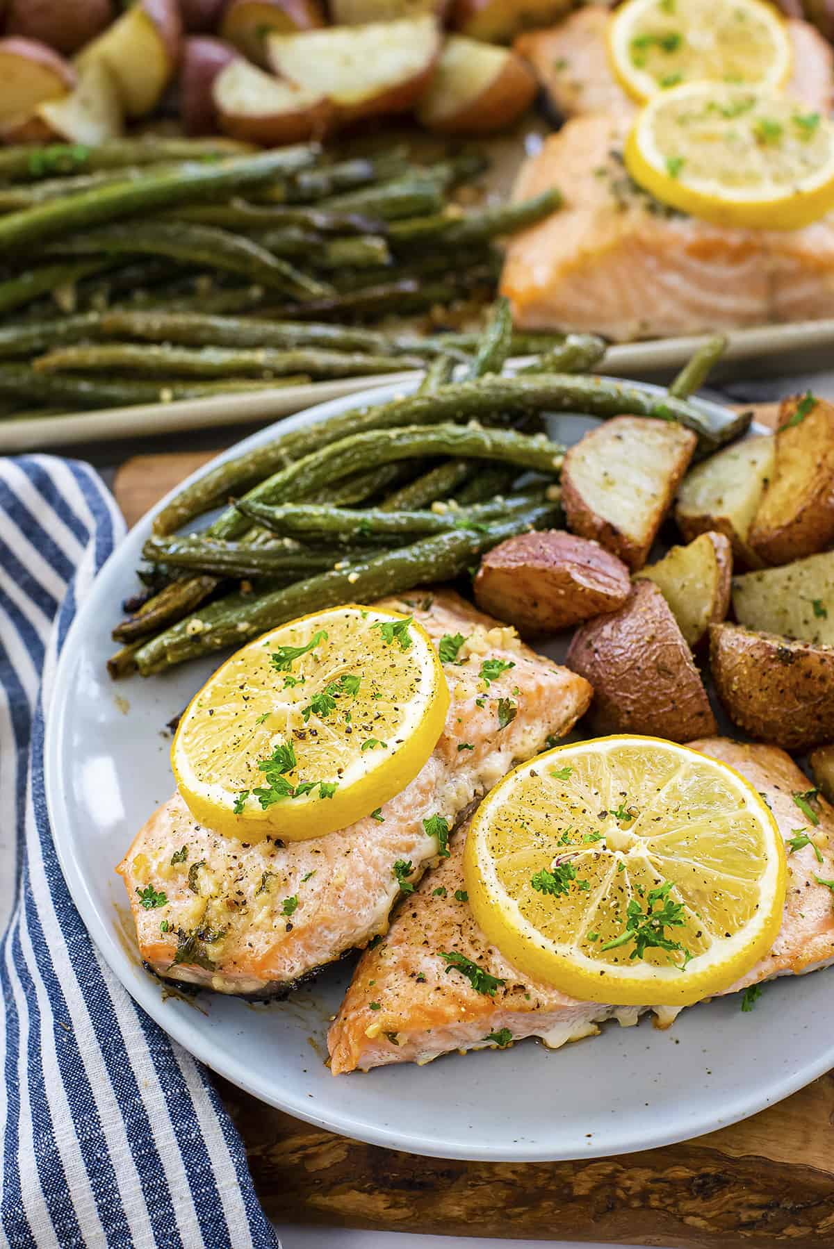 Roasted salmon, green beans, and potatoes on plate.