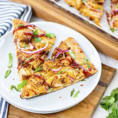 BBQ chicken flatbread on white plate.