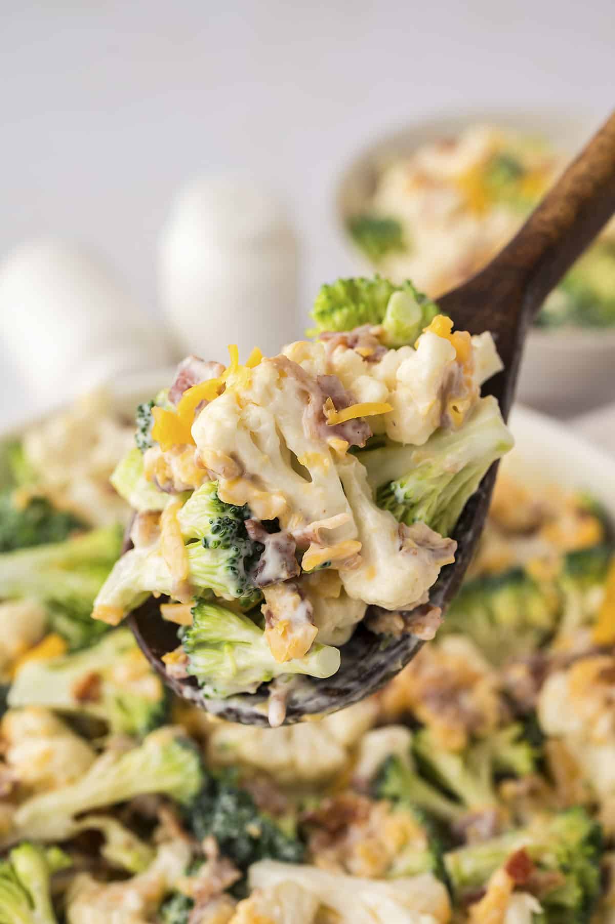 Amish broccoli salad on wooden spoon.
