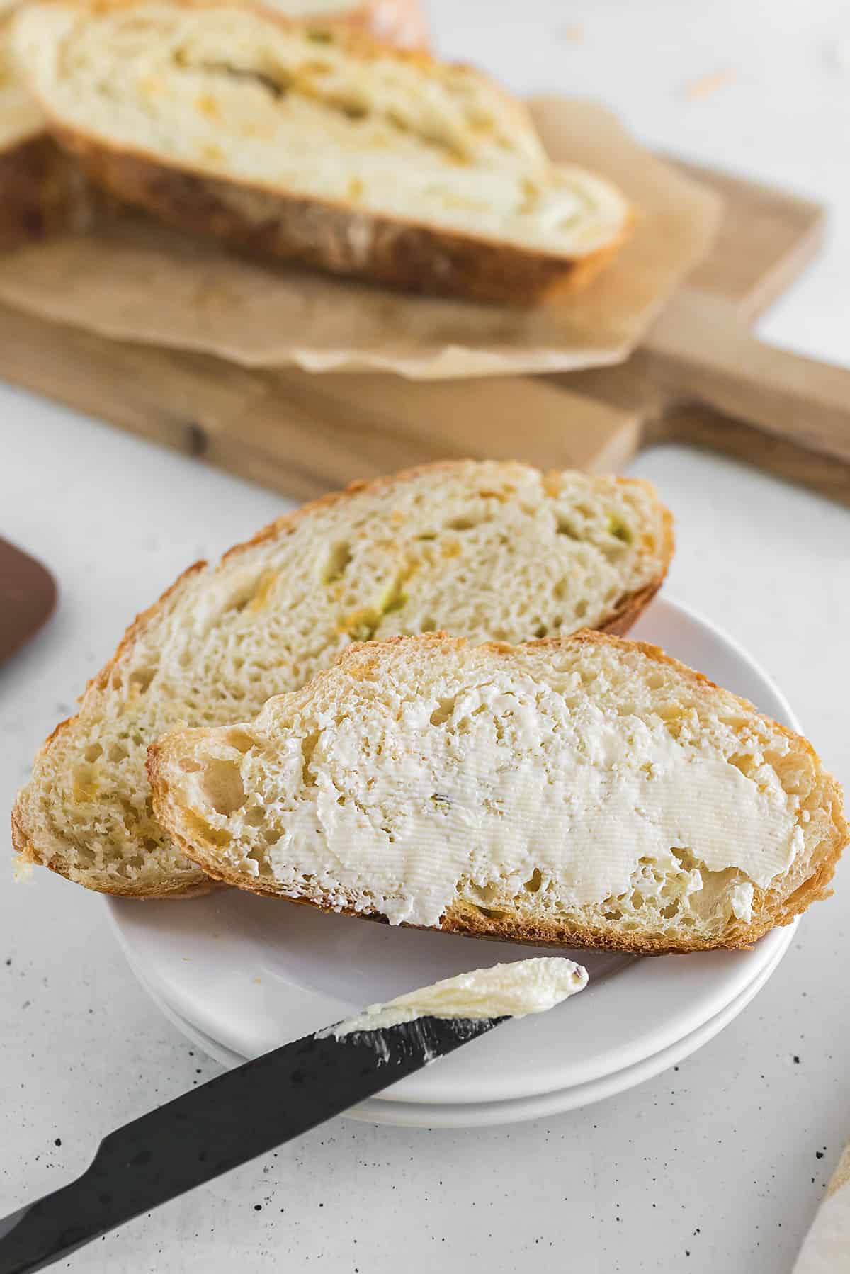 Sliced bread spread with butter.